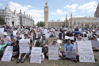 Protesters sit silently in Parliament Square